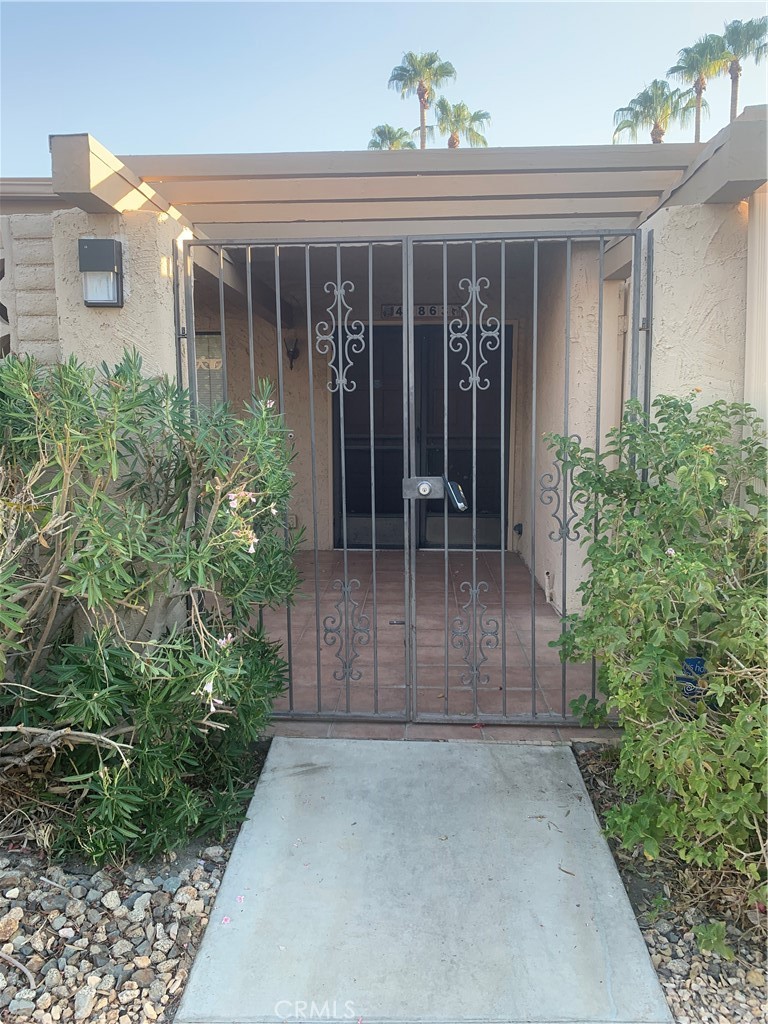 front view of a house with potted plants