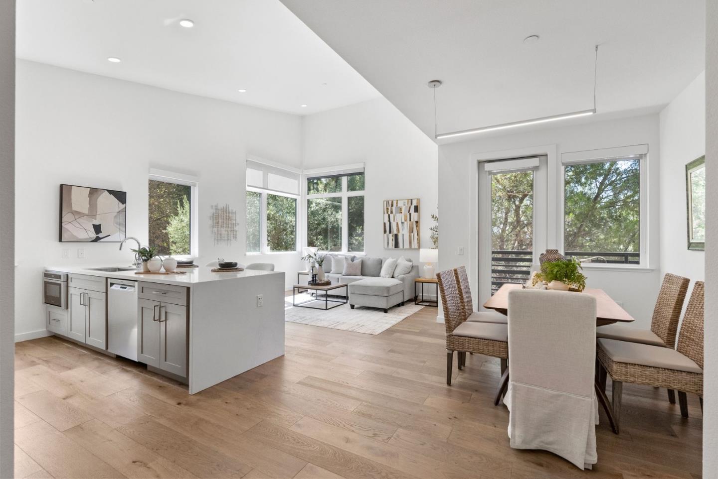 a living room with furniture and large windows