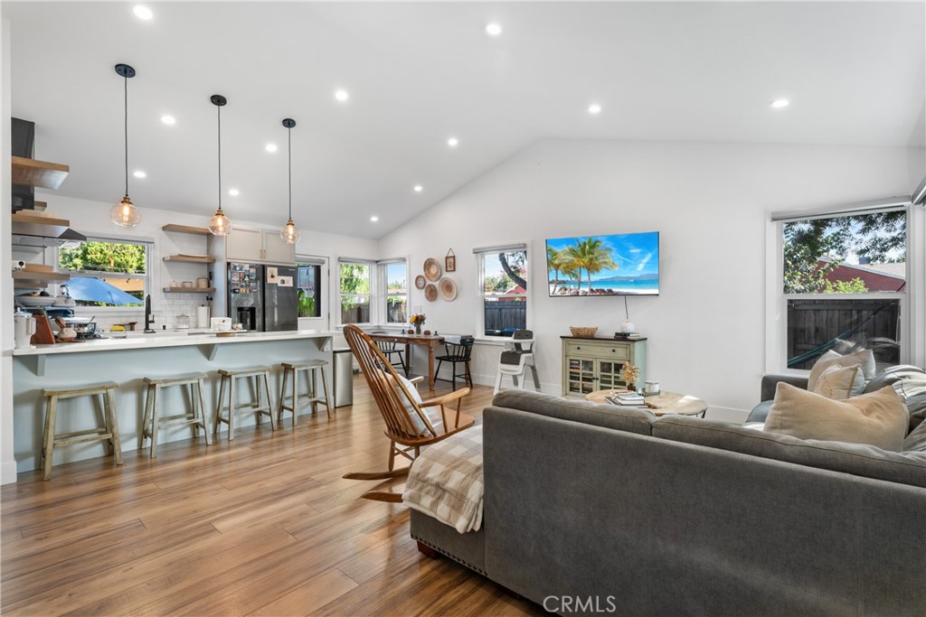 a living room with lots of furniture and a wooden floor