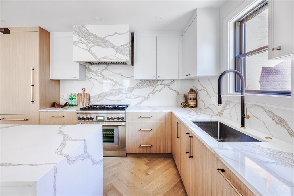 a kitchen with cabinets a sink and appliances