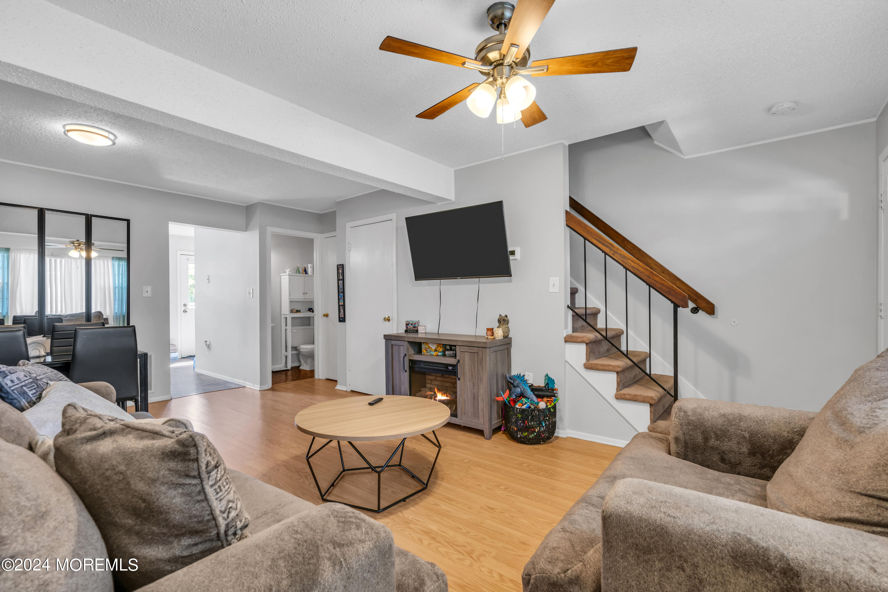 a living room with furniture a fireplace and a flat screen tv