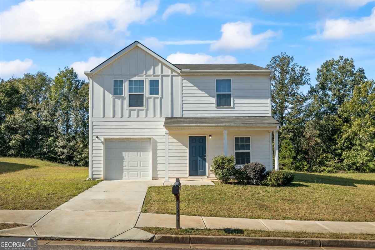 a front view of a house with a yard