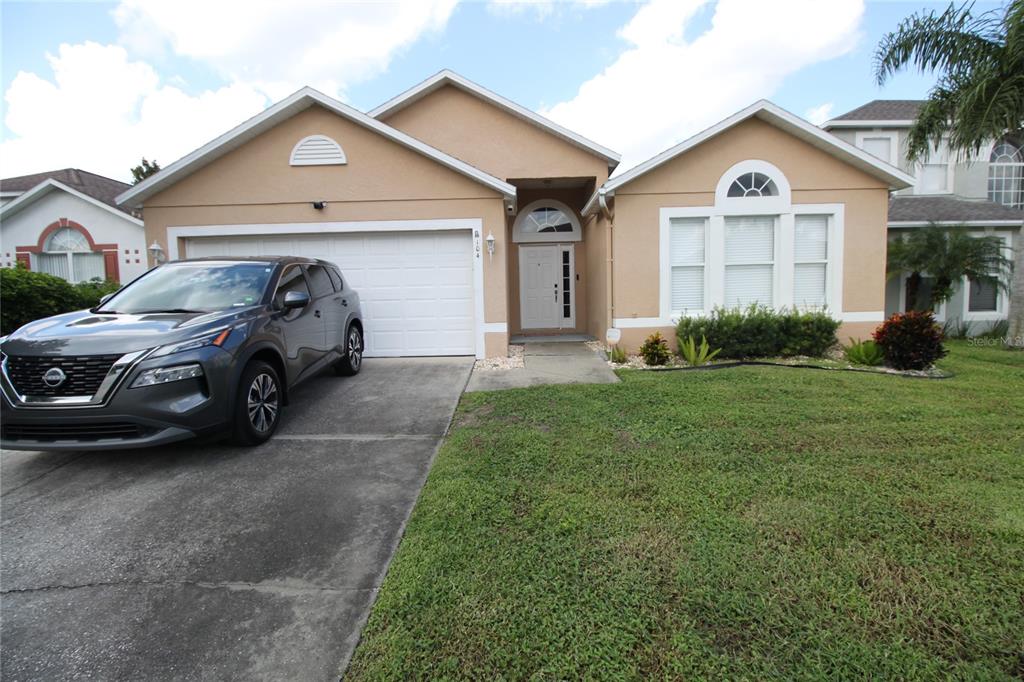 a front view of a house with a yard and garage