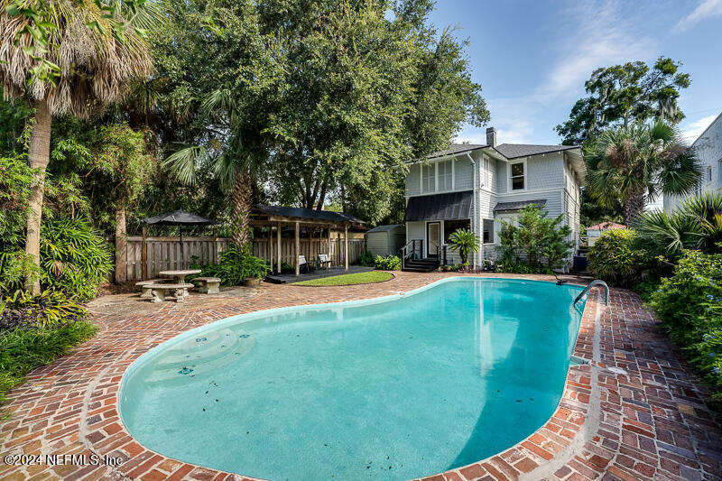 a view of a house with swimming pool and sitting area