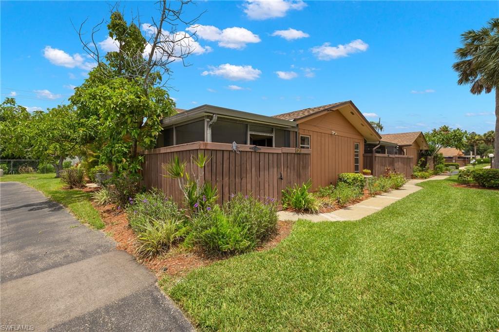 View of side of property featuring a yard