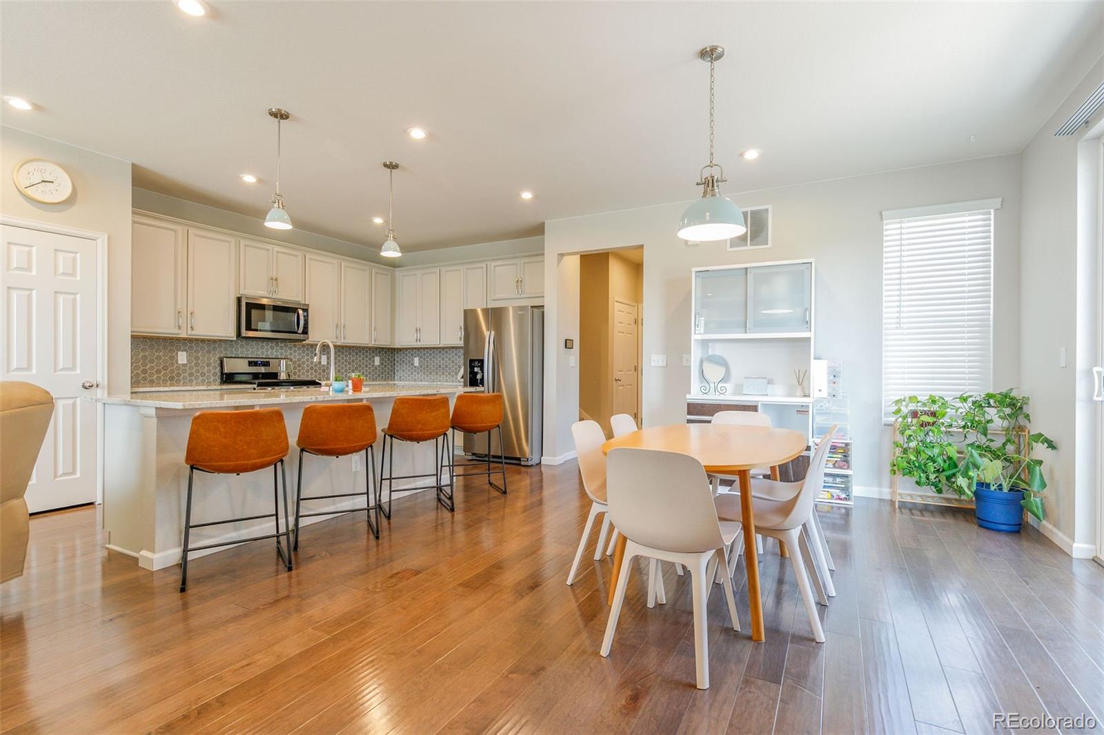 a view of a dining room with furniture and wooden floor