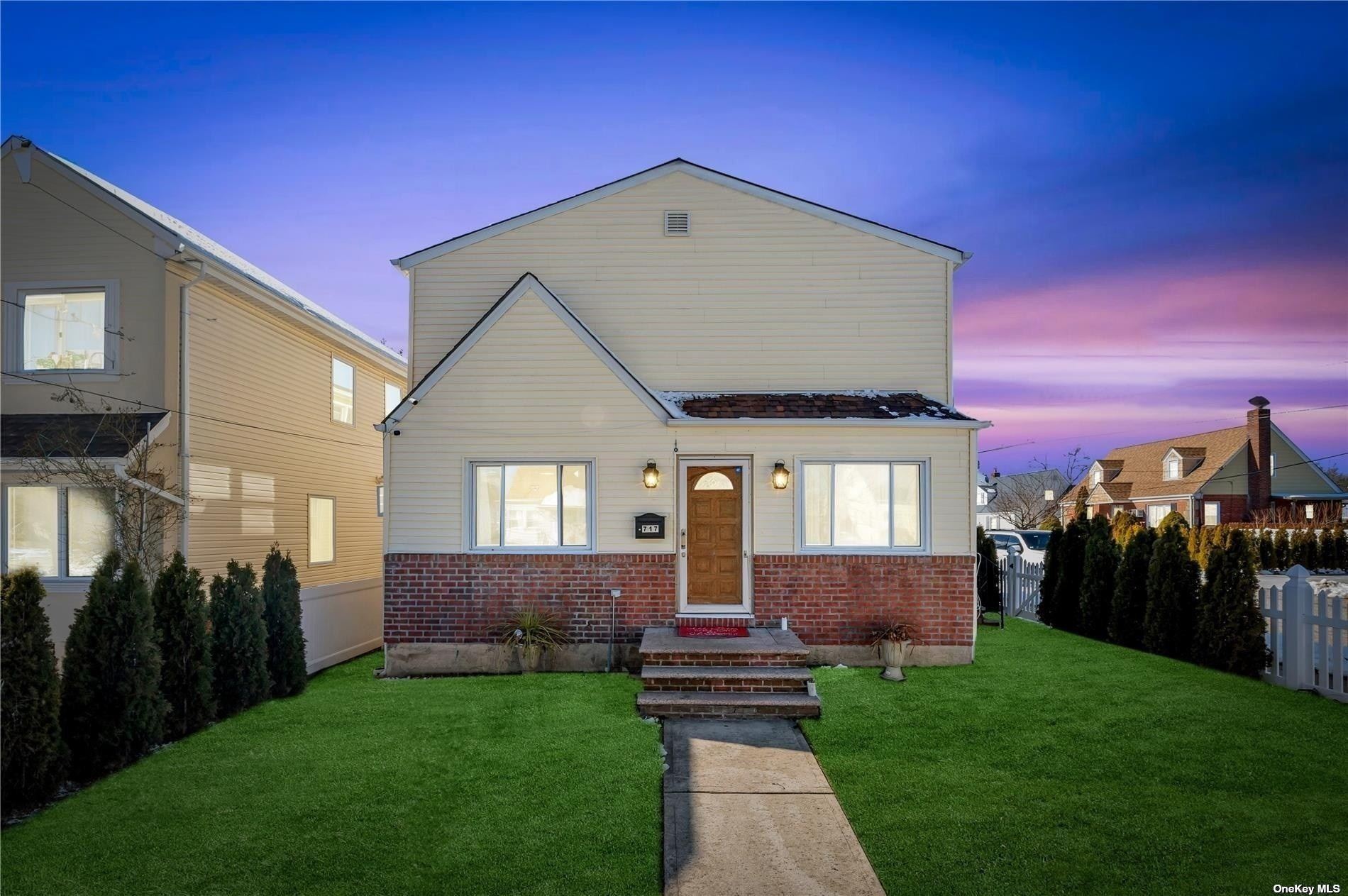 a front view of a house with a yard