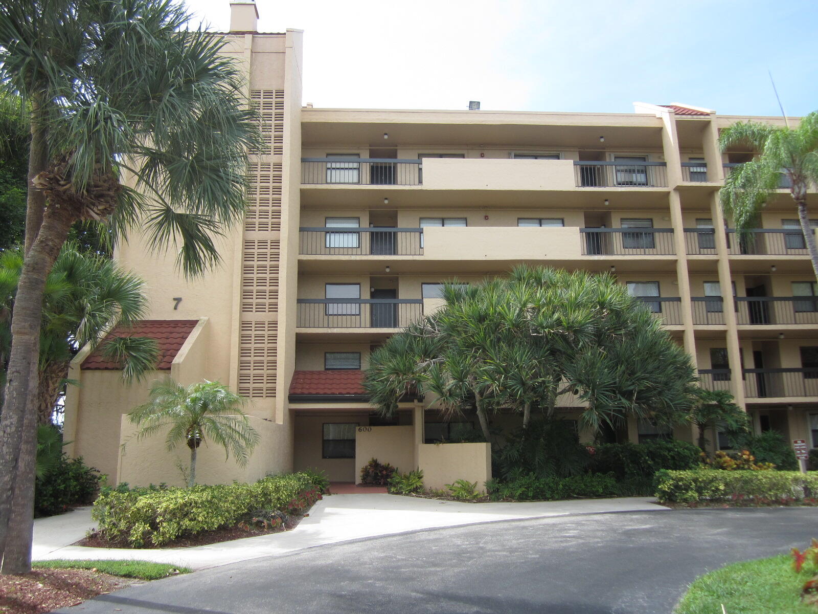 a front view of a building with a garden