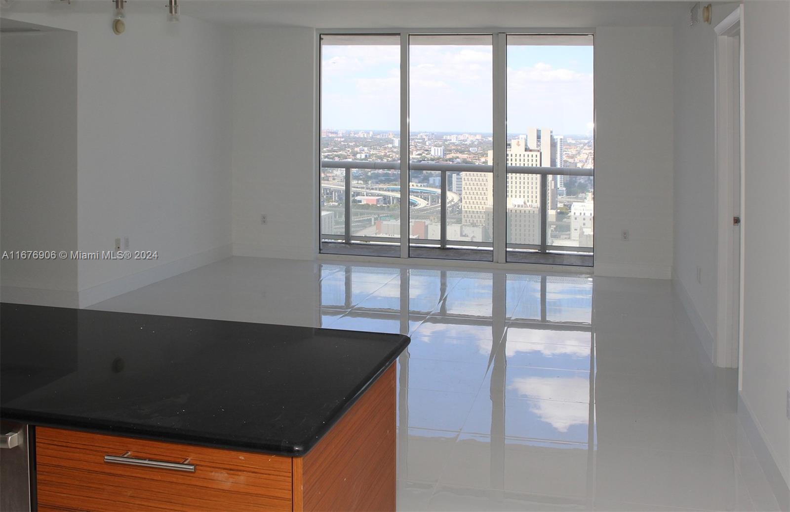 an outdoor view of an empty room and window