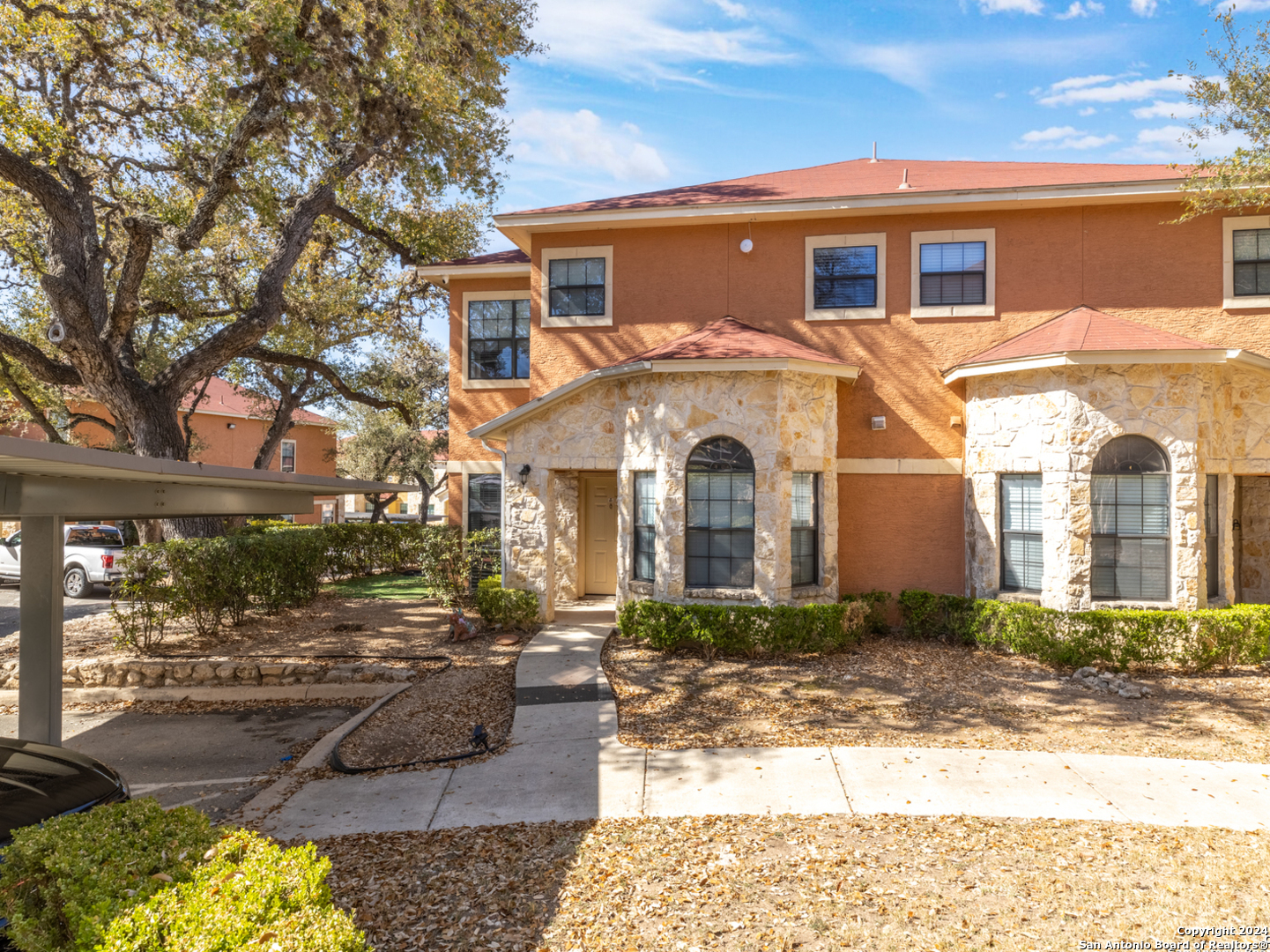 a front view of a house with garden