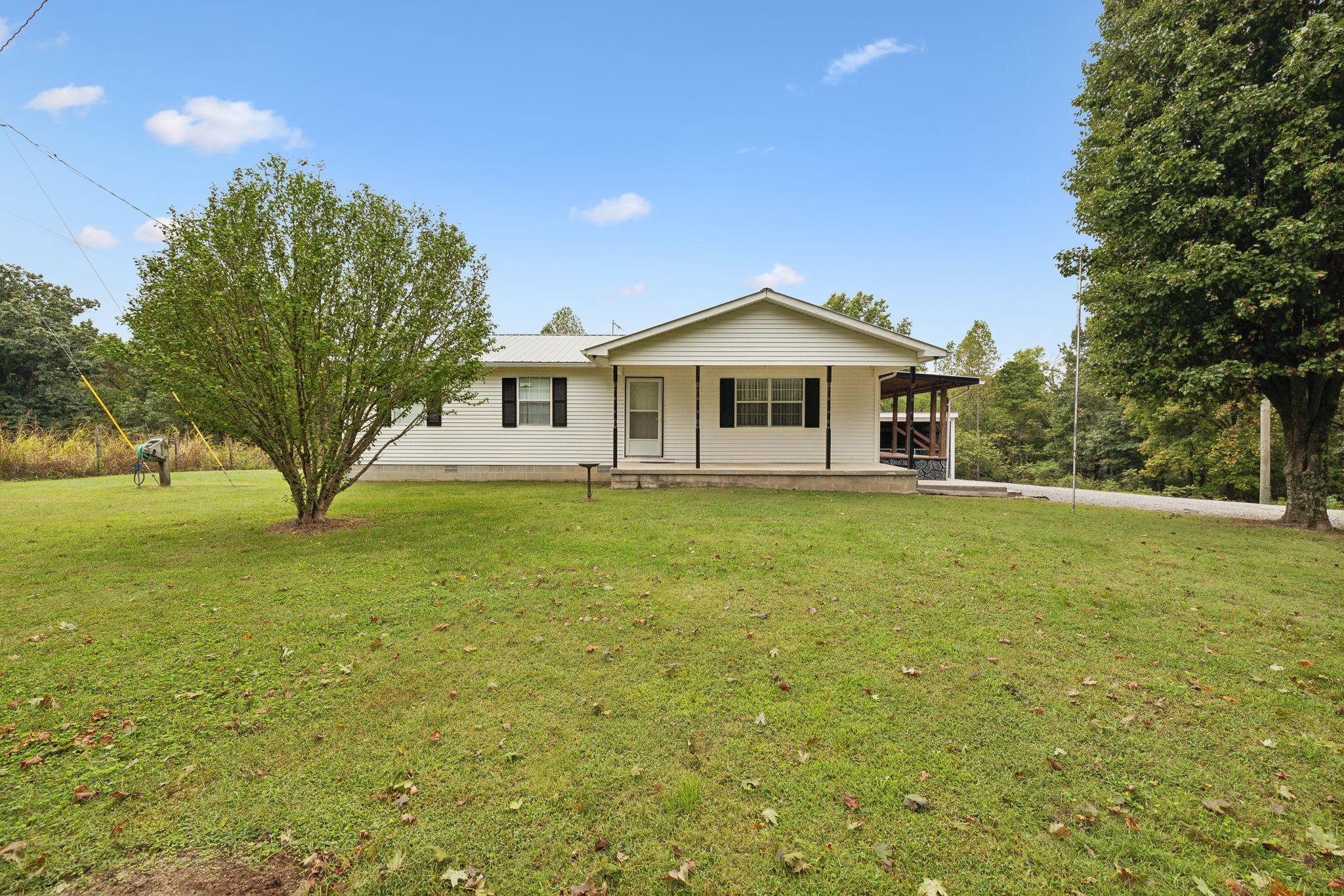 a front view of a house with yard and green space