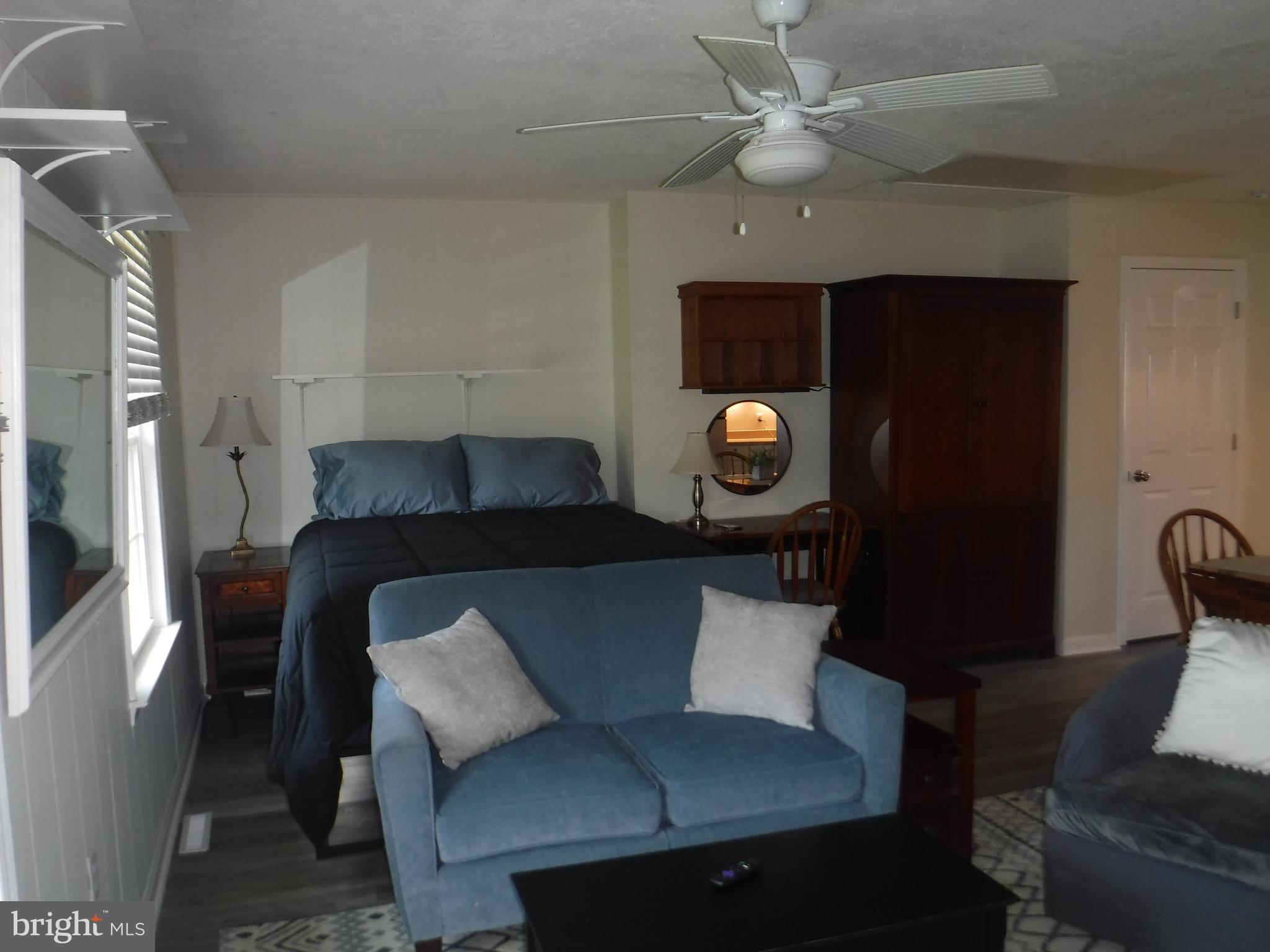 a living room with a couch and a chandelier