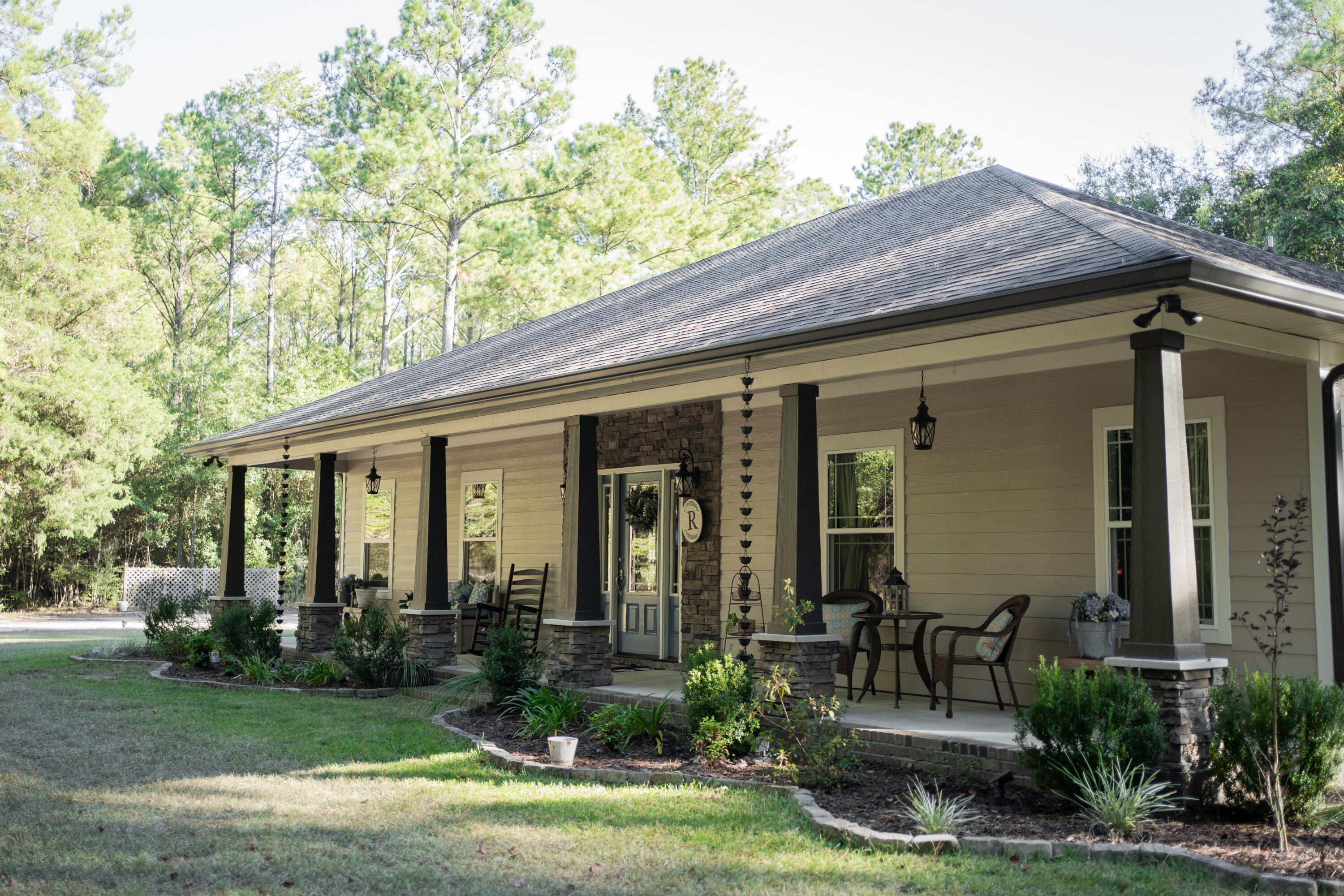 a front view of house with yard and outdoor seating