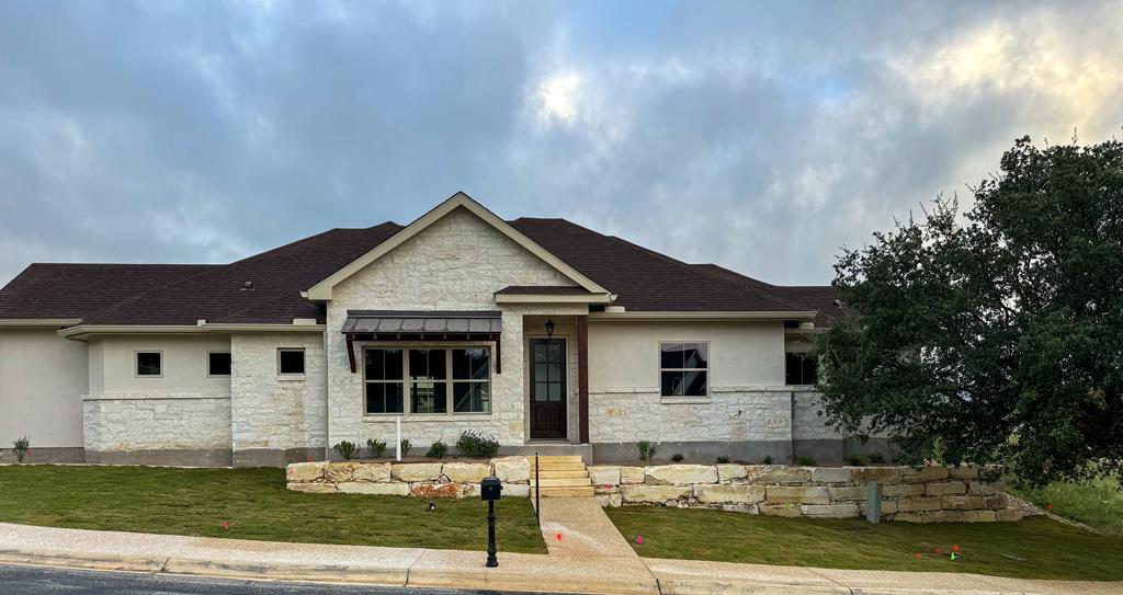 a front view of a house with garden