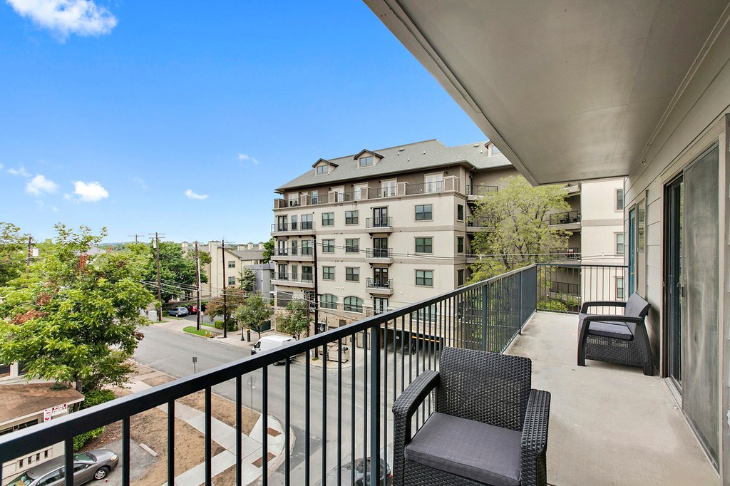 a view of balcony with furniture