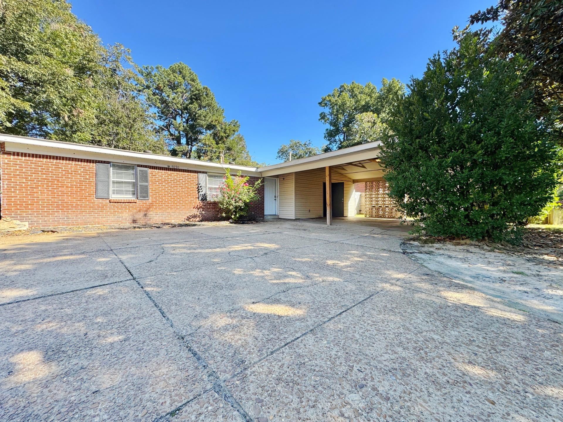 a view of a house with a yard and garage