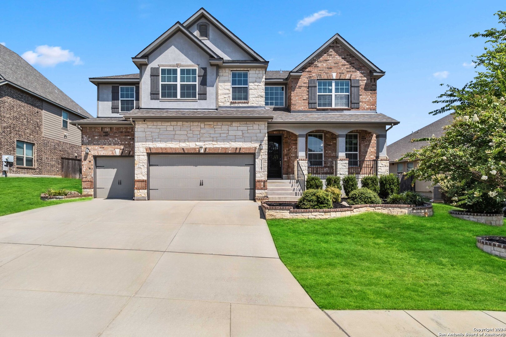 a front view of a house with a yard and garage