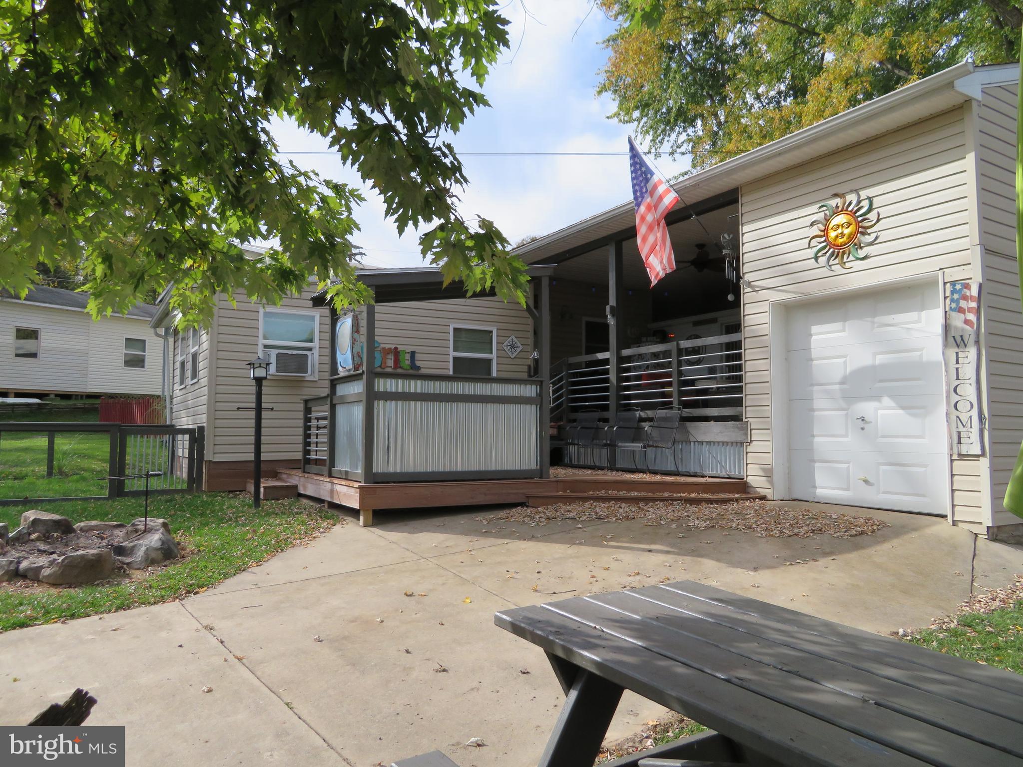 a view of backyard with barbeque grill and wooden fence