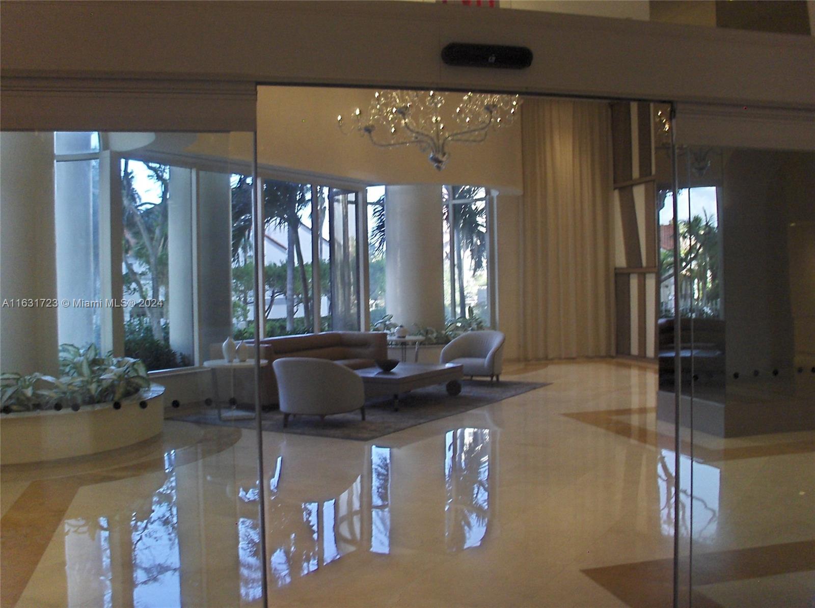 a living room with furniture and large windows