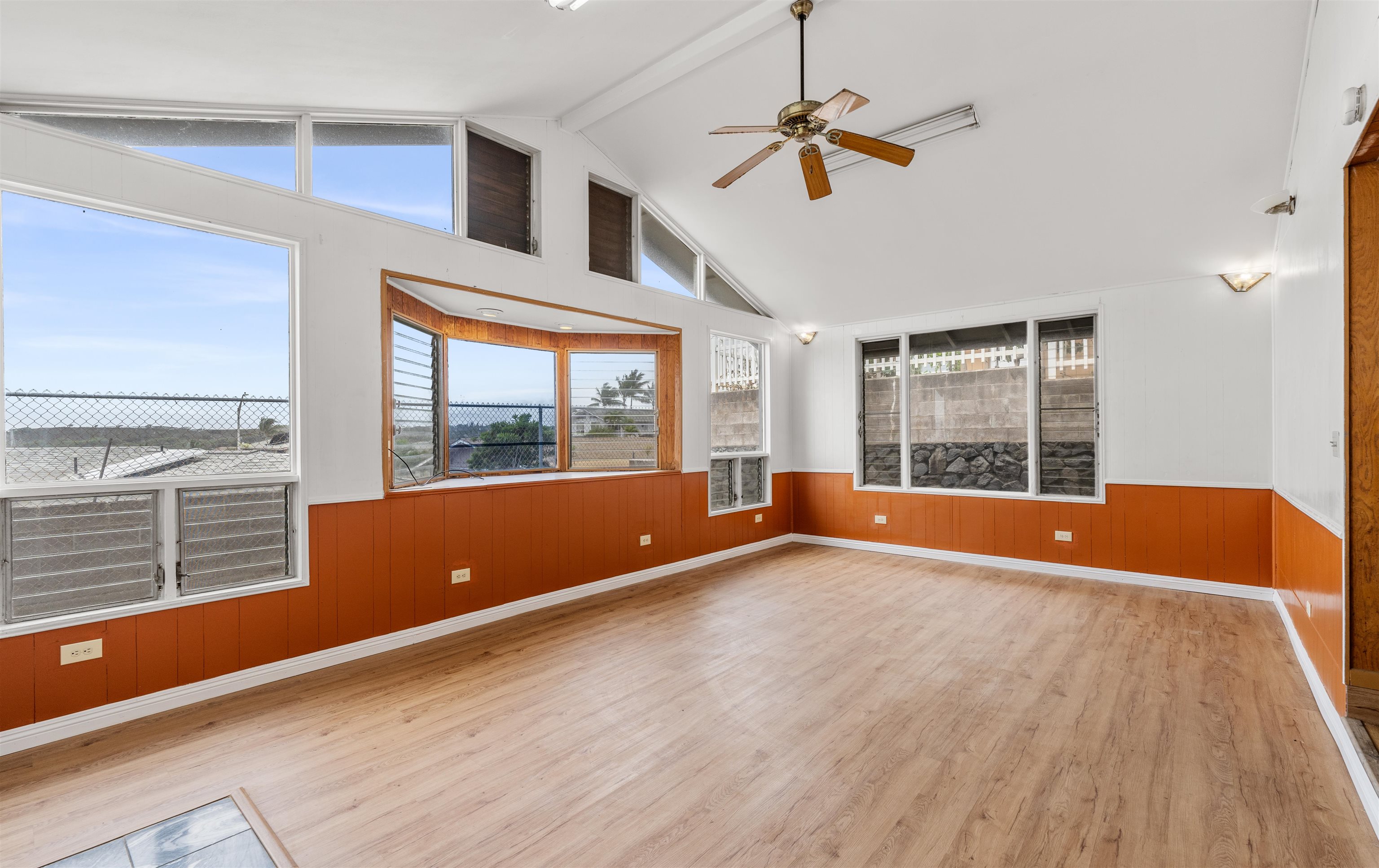 a view of room with window ceiling fan and hardwood floor