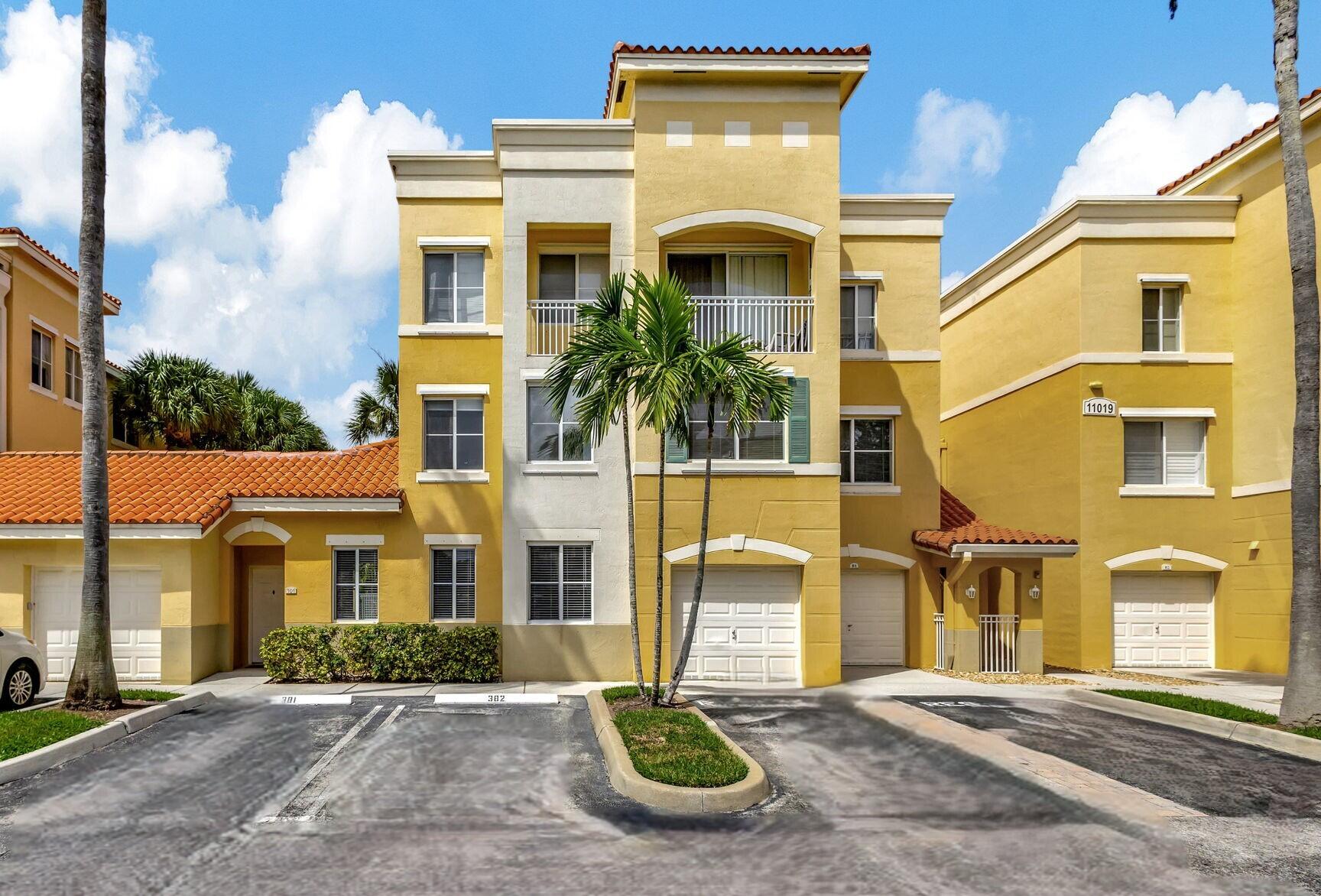 a front view of a residential apartment building with a yard