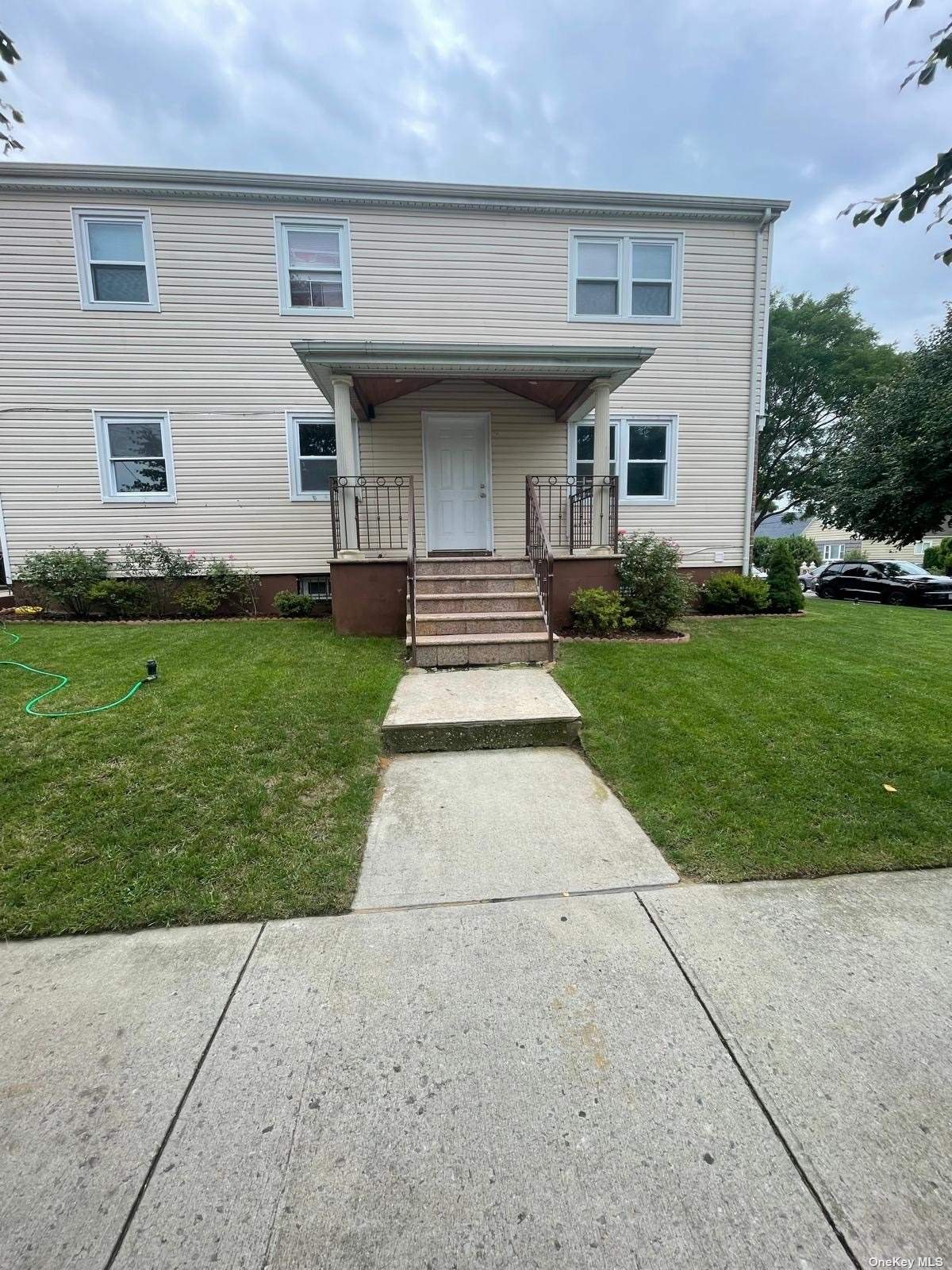 a front view of a house with a yard