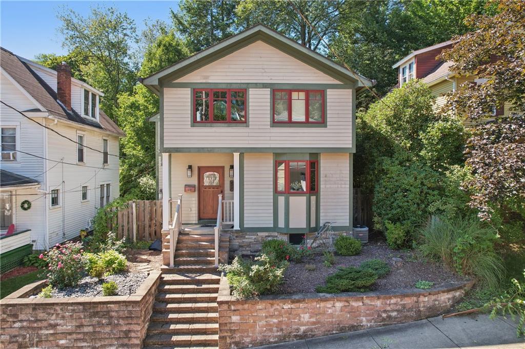 a front view of a house with garden