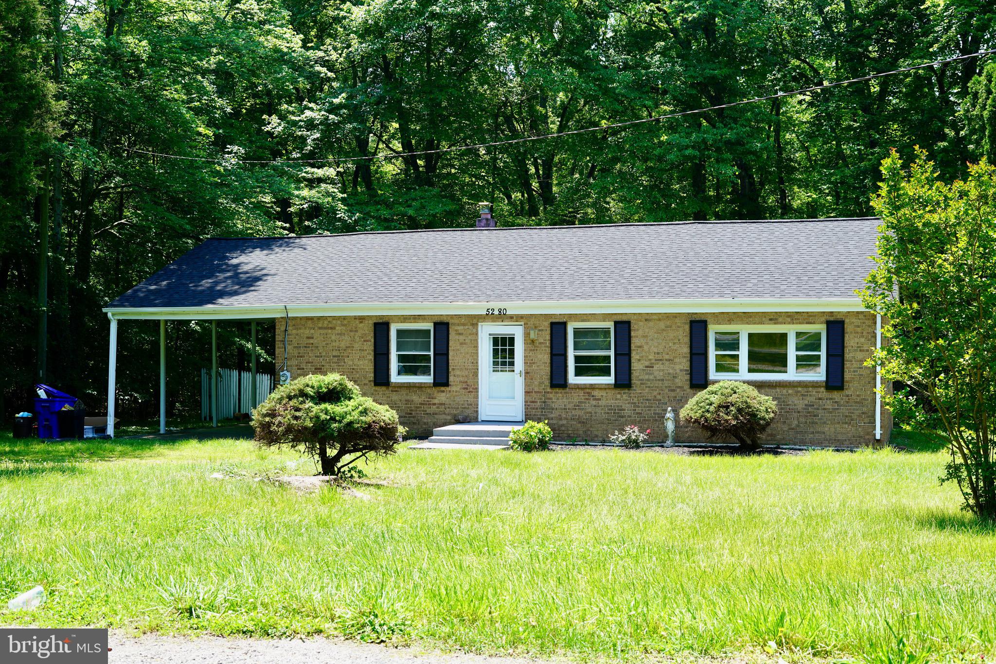 a front view of a house with a yard and porch