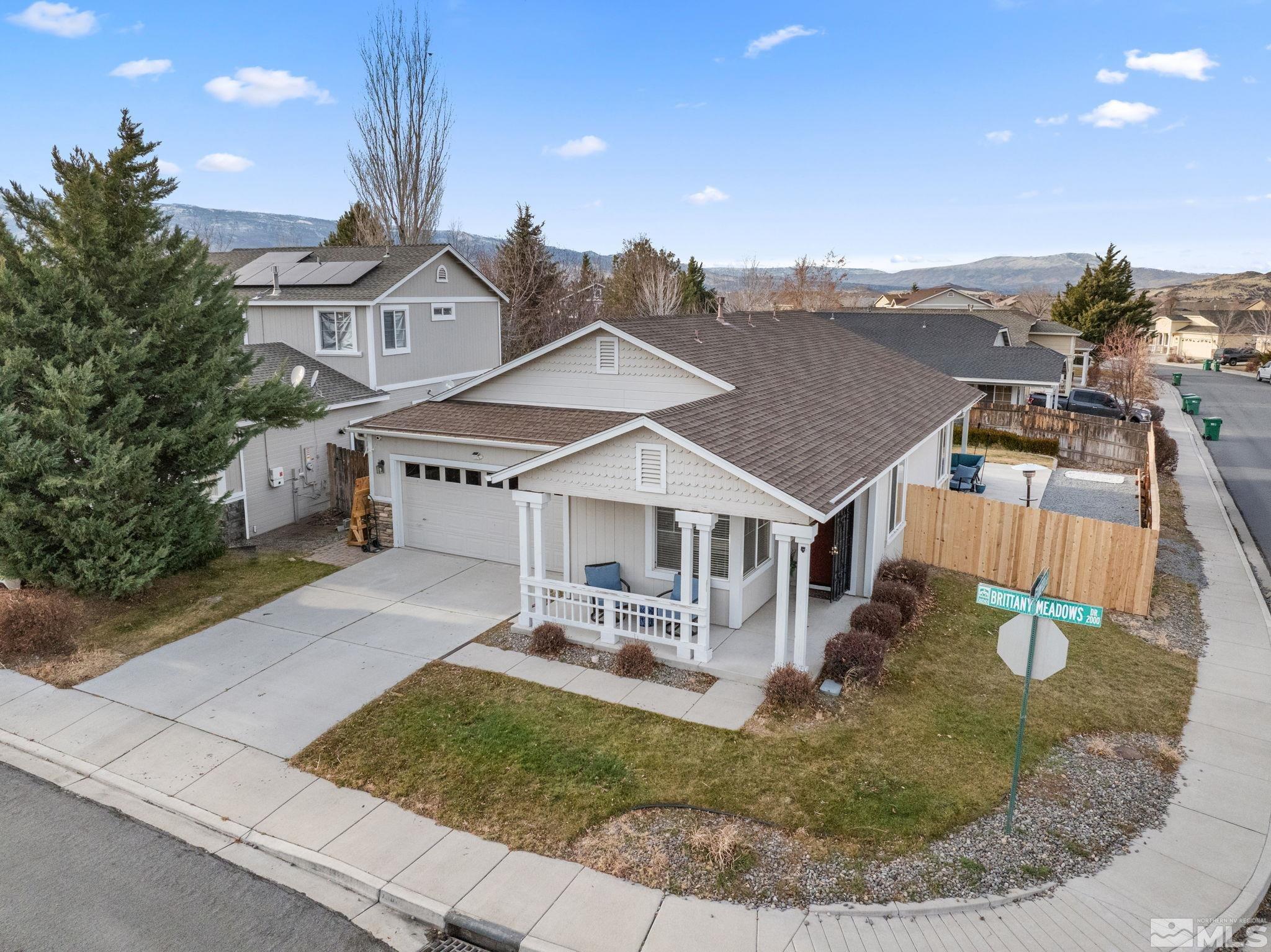 an aerial view of a house with a yard