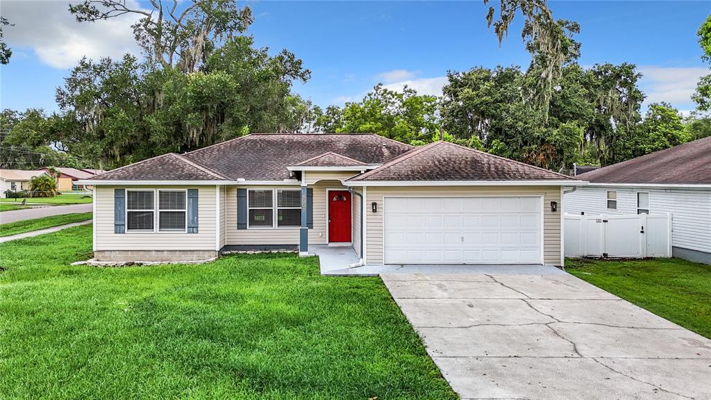 a front view of a house with a yard and garage