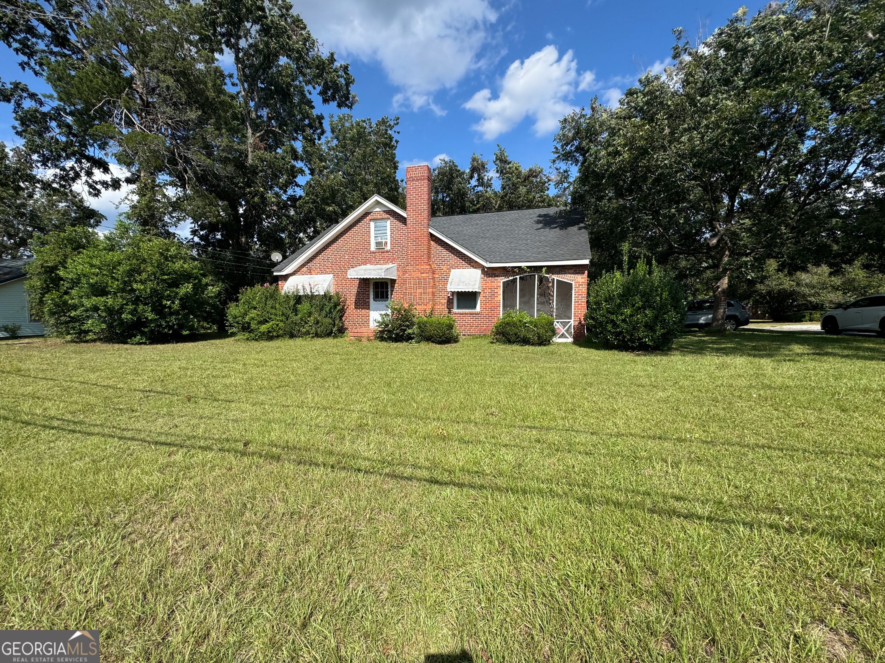 a view of a house with pool and a big yard