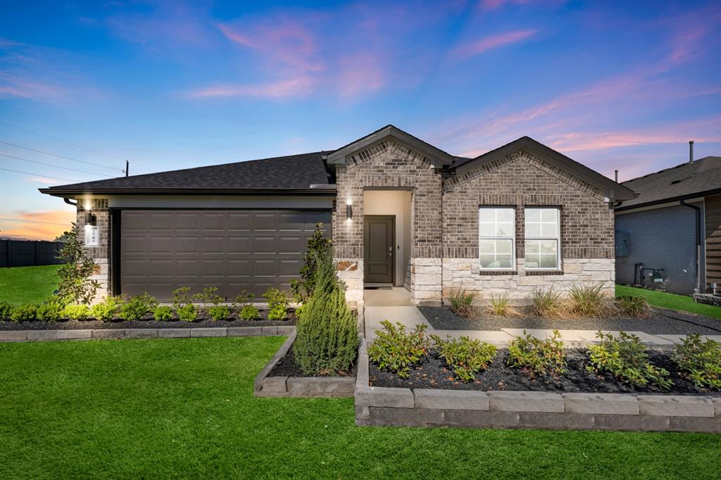 a front view of a house with a garden and plants