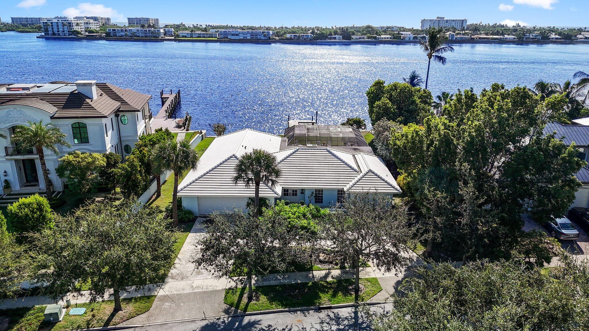 a aerial view of a house with garden and lake view