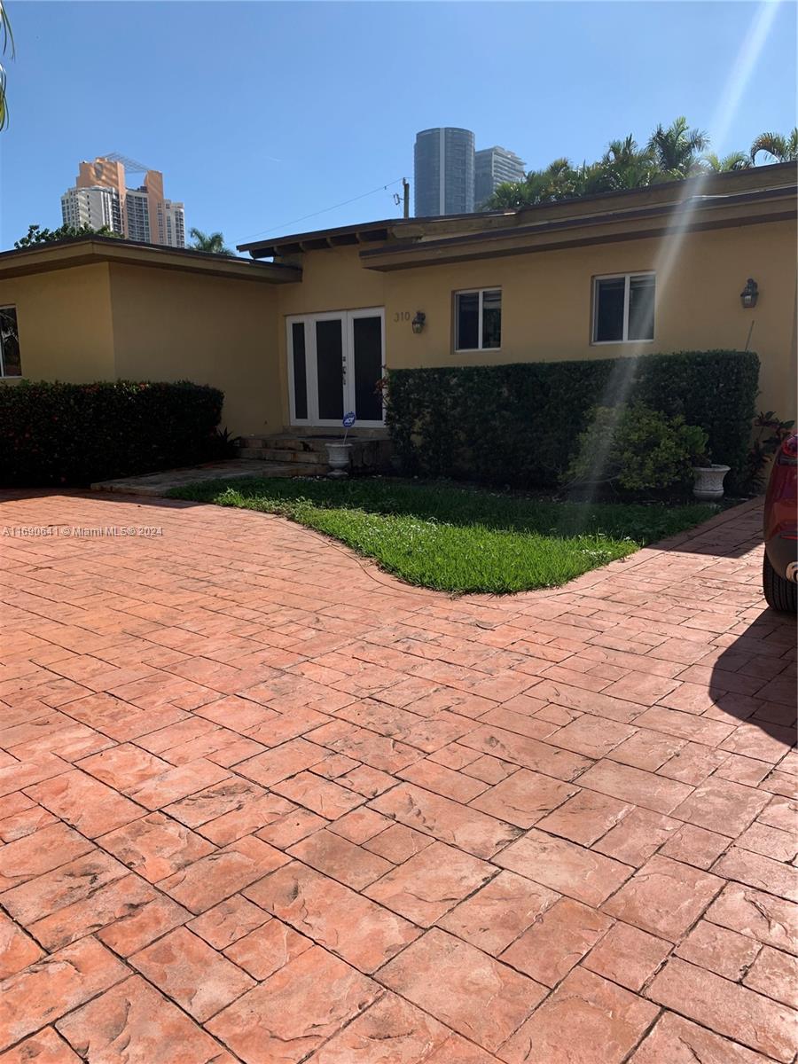 a front view of a house with a yard and a garage