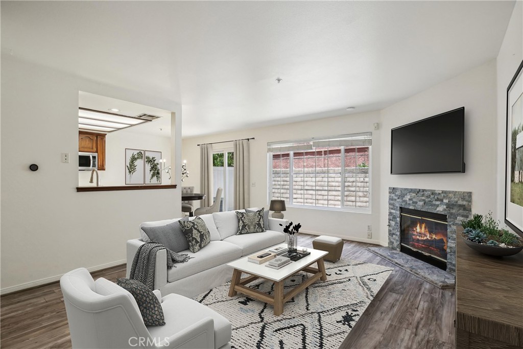 a living room with furniture a fireplace and a flat screen tv