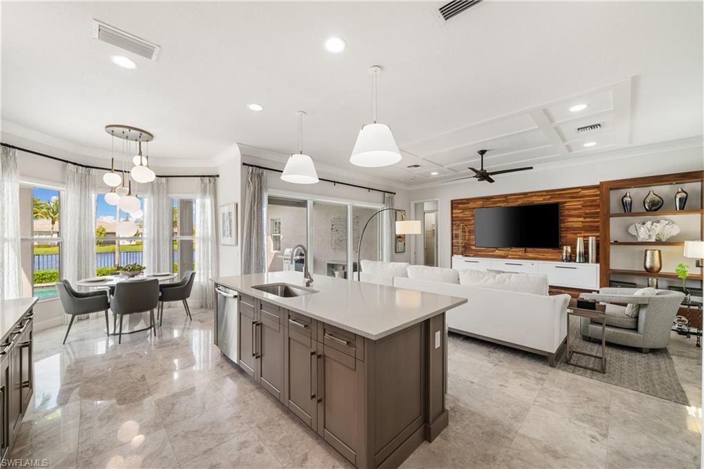 a large white kitchen with a large window and chairs