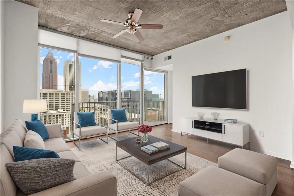 a living room with furniture and a flat screen tv