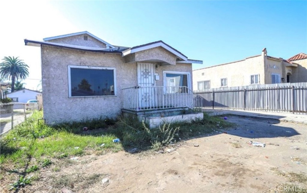 a view of a house with wooden fence