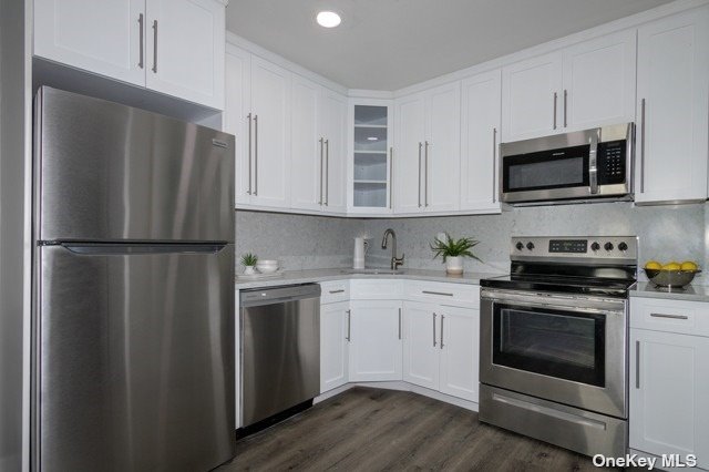 a kitchen with stainless steel appliances a refrigerator stove and microwave