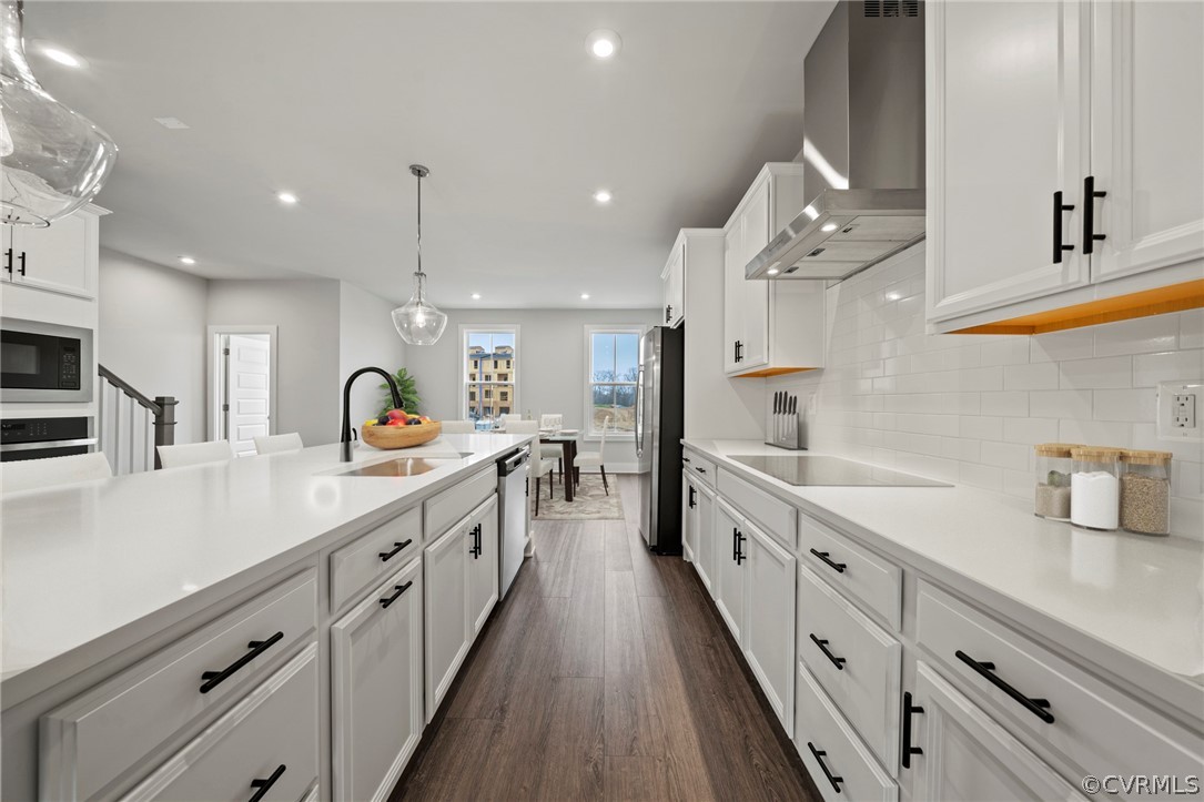 a large kitchen with stainless steel appliances lots of counter space and a sink