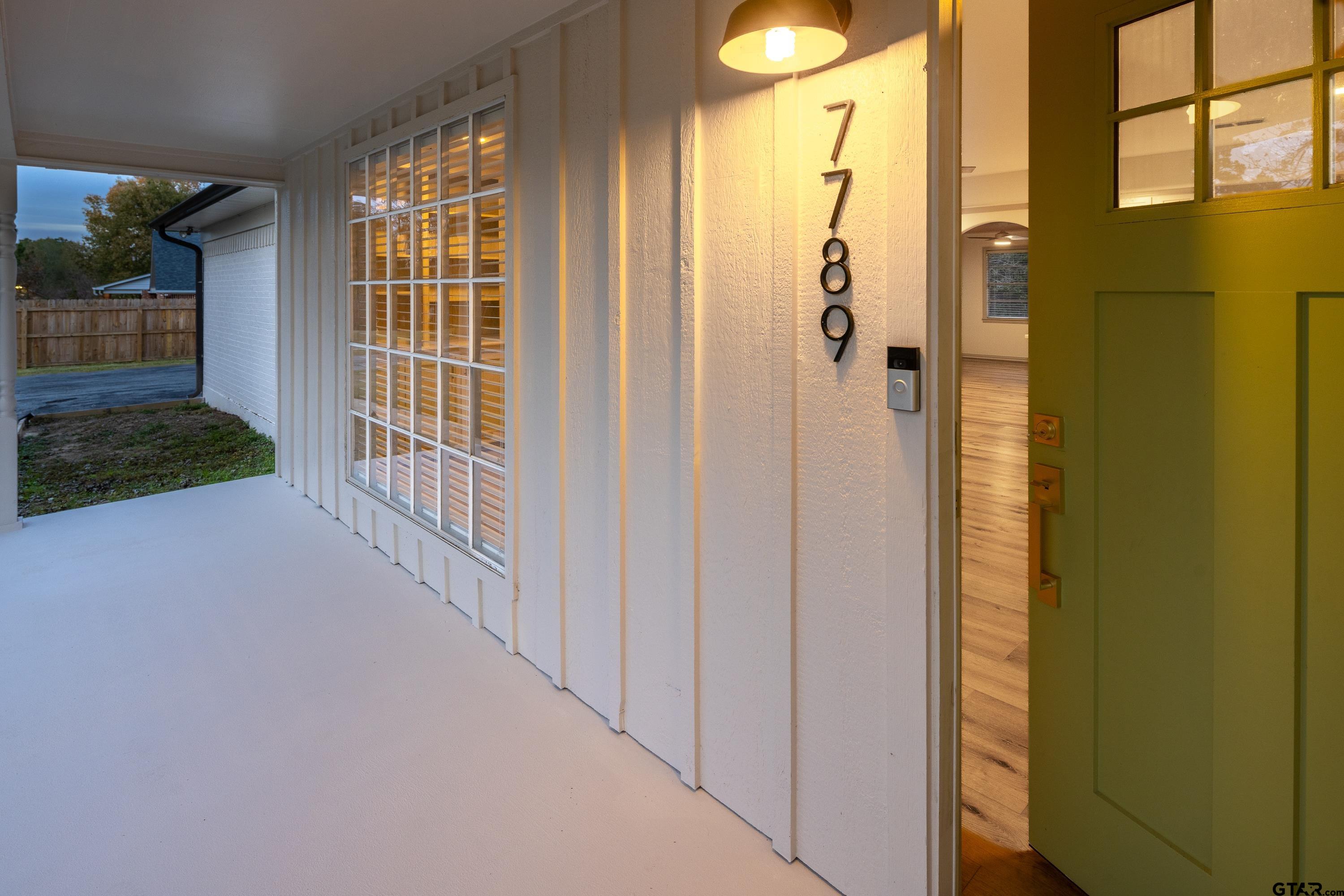 a view of a porch with wooden floor