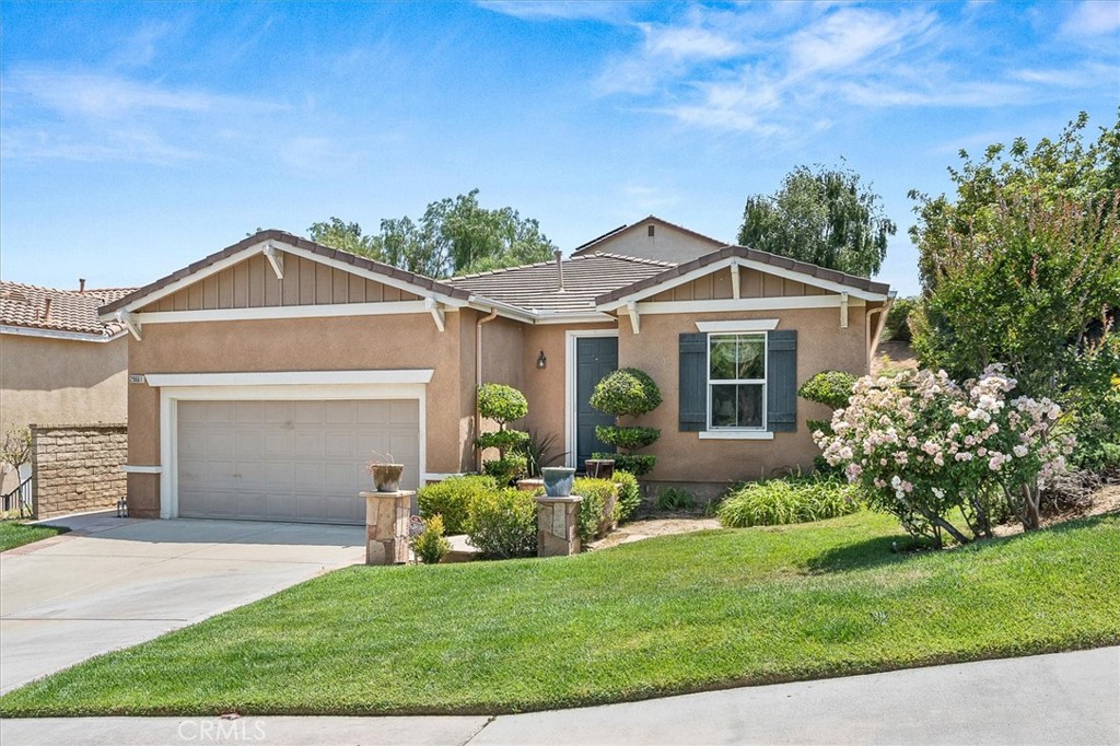 a front view of a house with a garden and plants