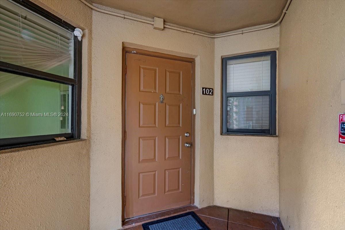 a view of front door with wooden floor