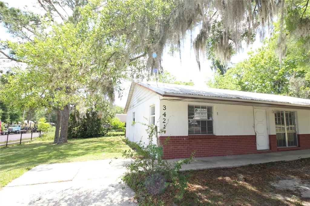 a view of a house with yard and a tree