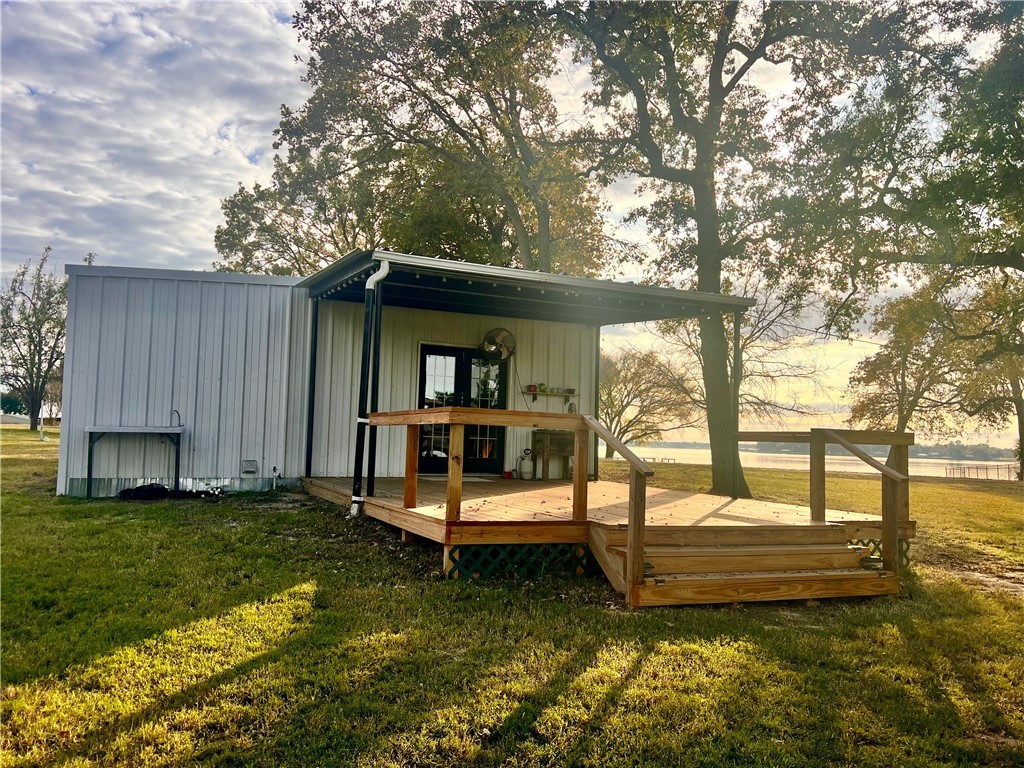 a view of a house with backyard and sitting area