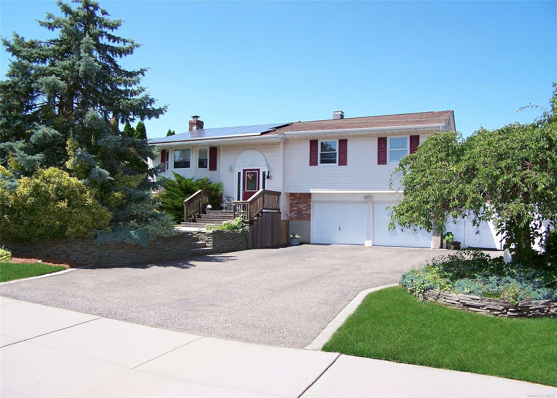 a front view of a house with a yard and a garage