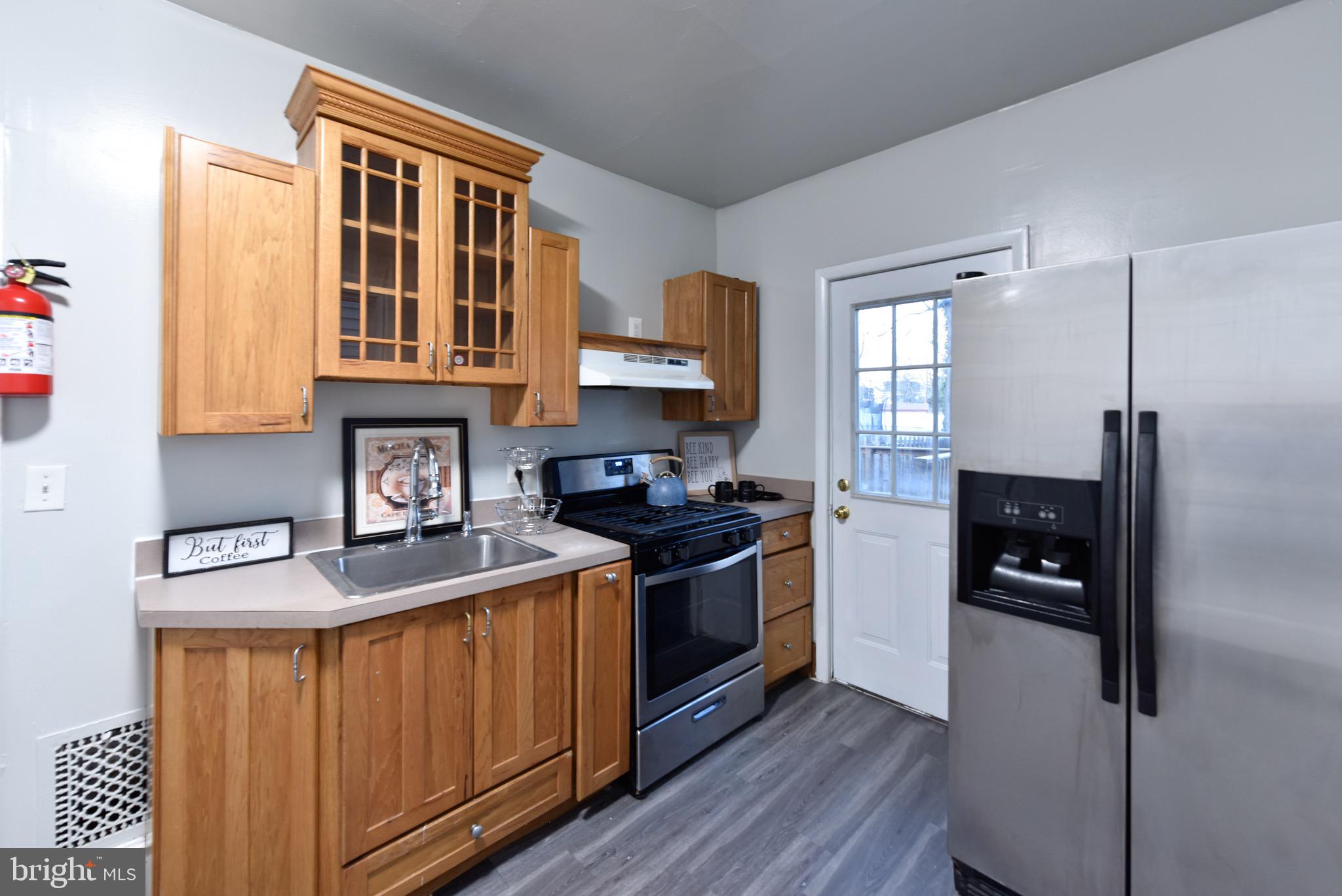 a kitchen with stainless steel appliances granite countertop a stove a refrigerator and a sink