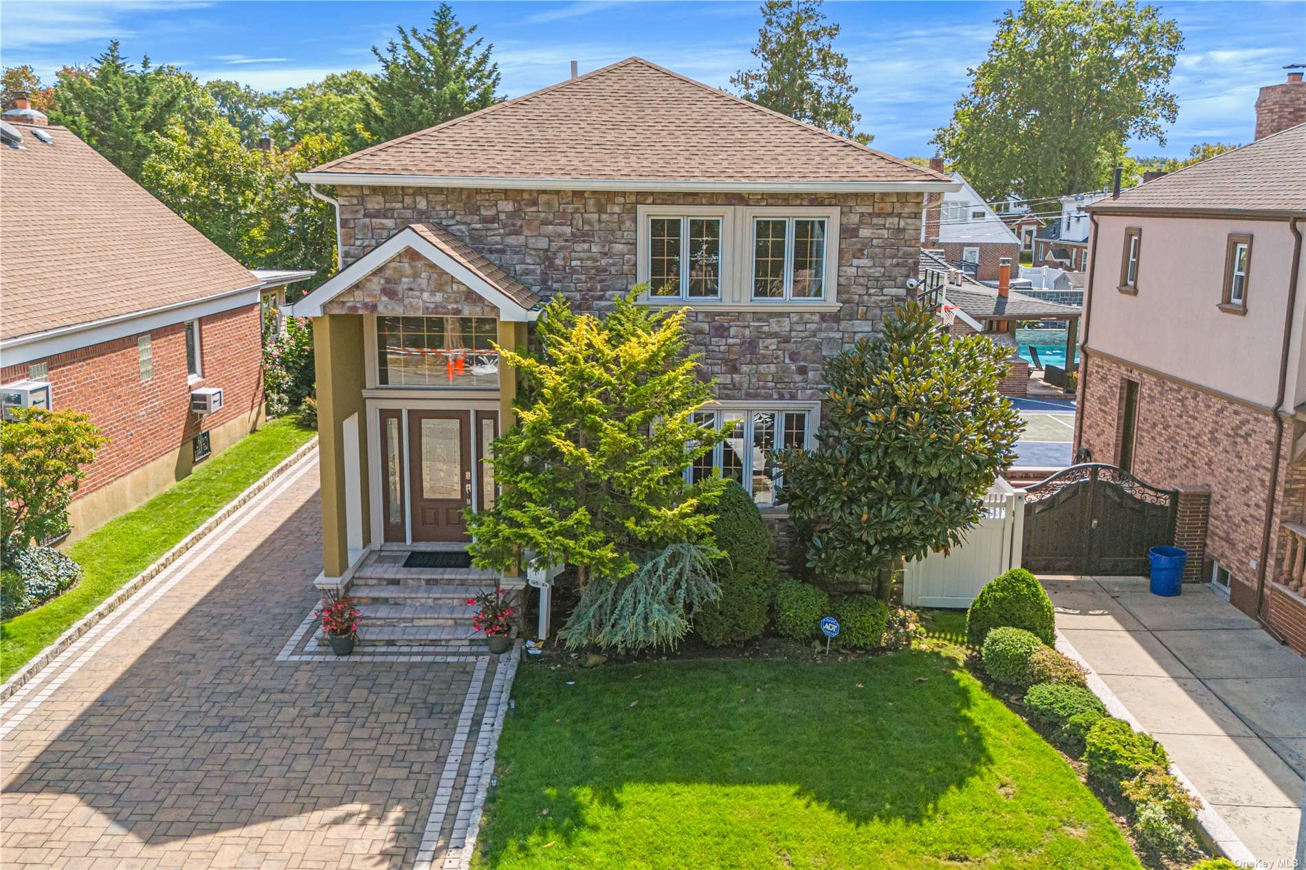 a front view of a house with a garden