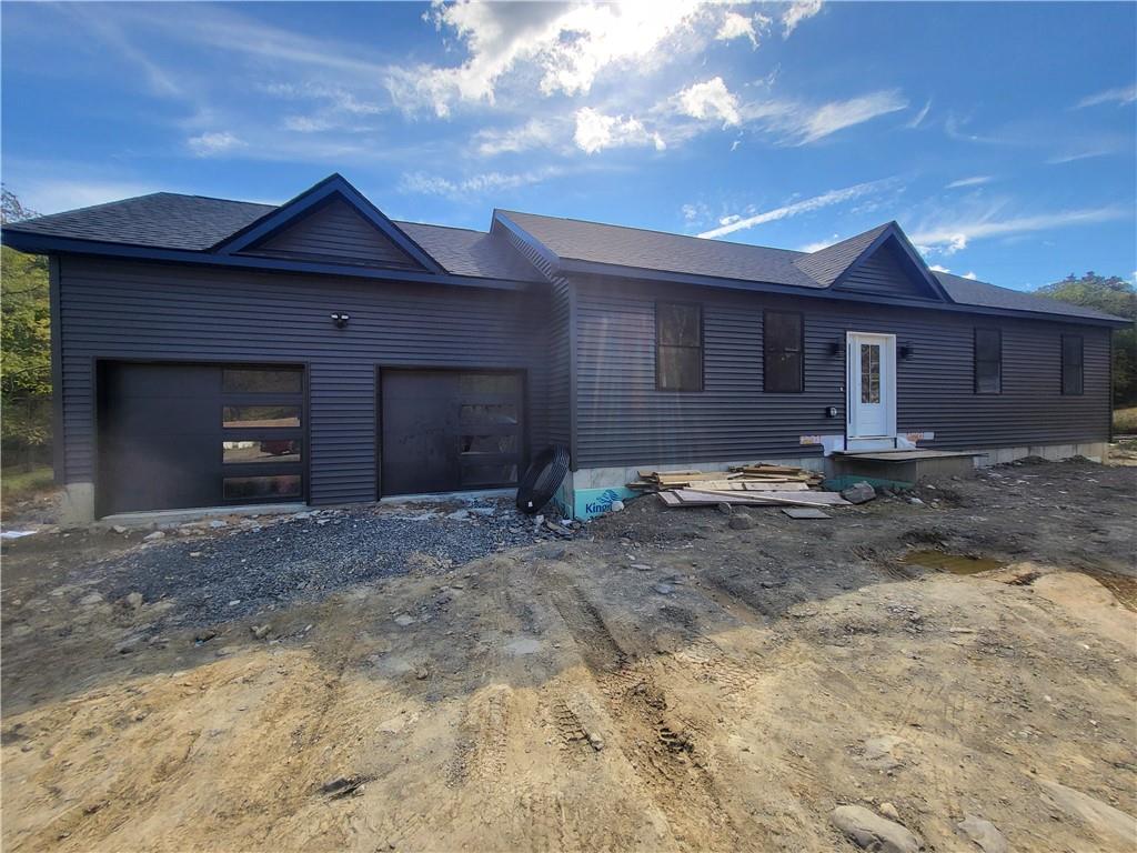 View of front facade featuring a garage