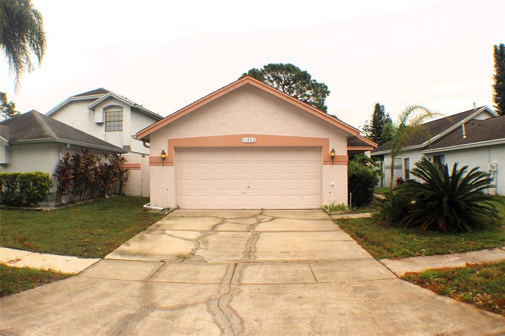 a view of a garage with a sink and a yard